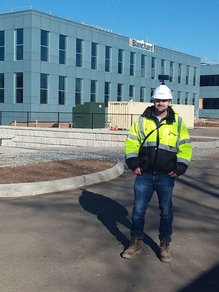 kevin lyons in front of building