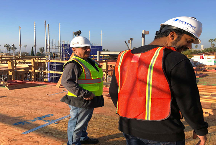 Men on construction site wearing hard hats with 360 cameras attached