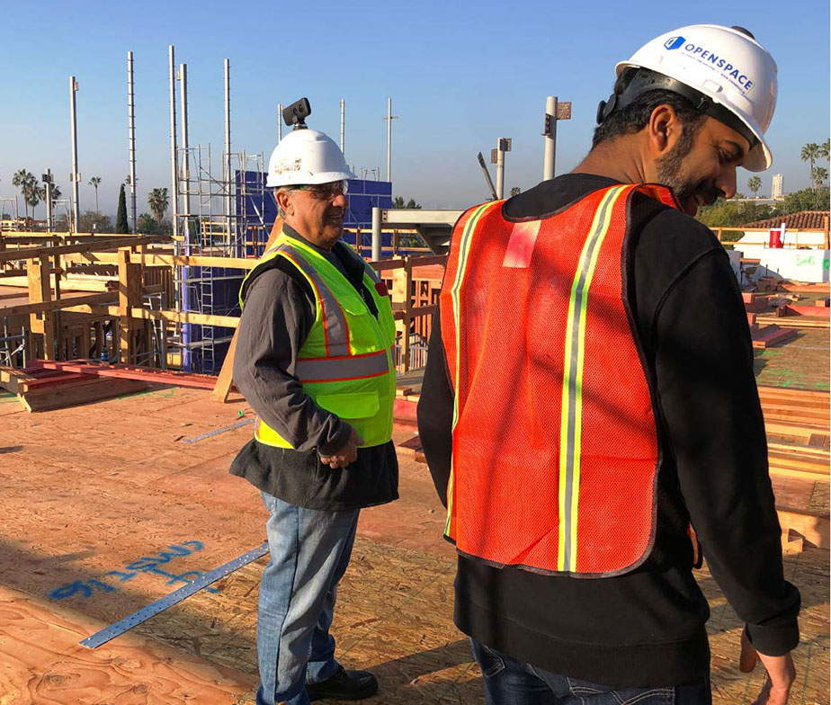 Men on construction site wearing hard hats with 360 cameras attached