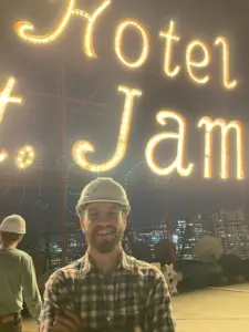 TJ Macklin posing in front of sign