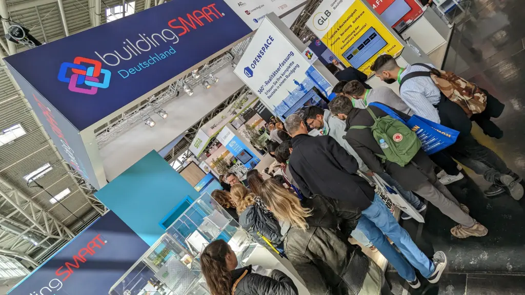A crowd of people in front of the OpenSpace booth at BAU 2023