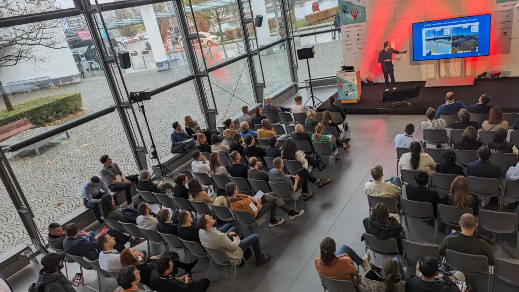 Crowded room with presenter on stage