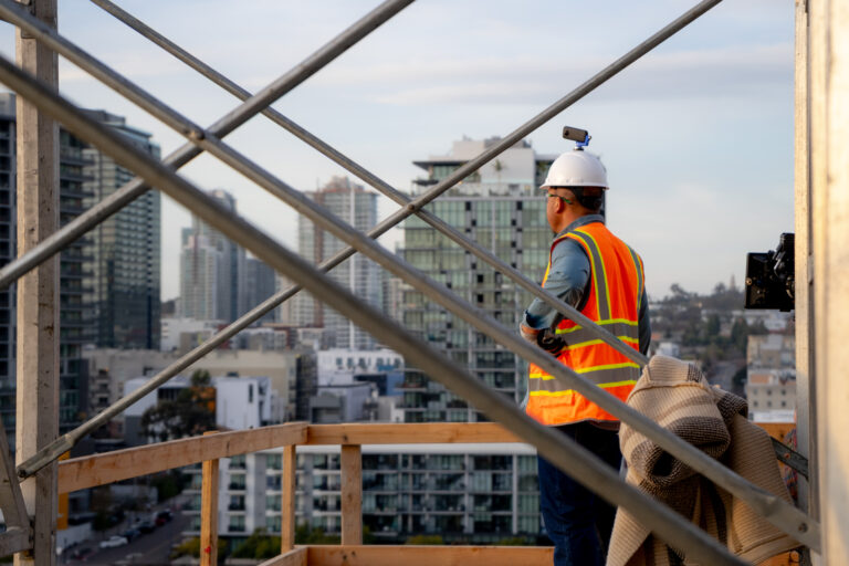 Construction Worker at job site looking at City Skyline