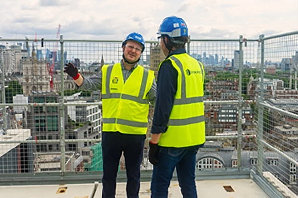 Sheet metal and HVAC contractors at a construction jobsite representing OpenSpace Spatial AI site documentation
